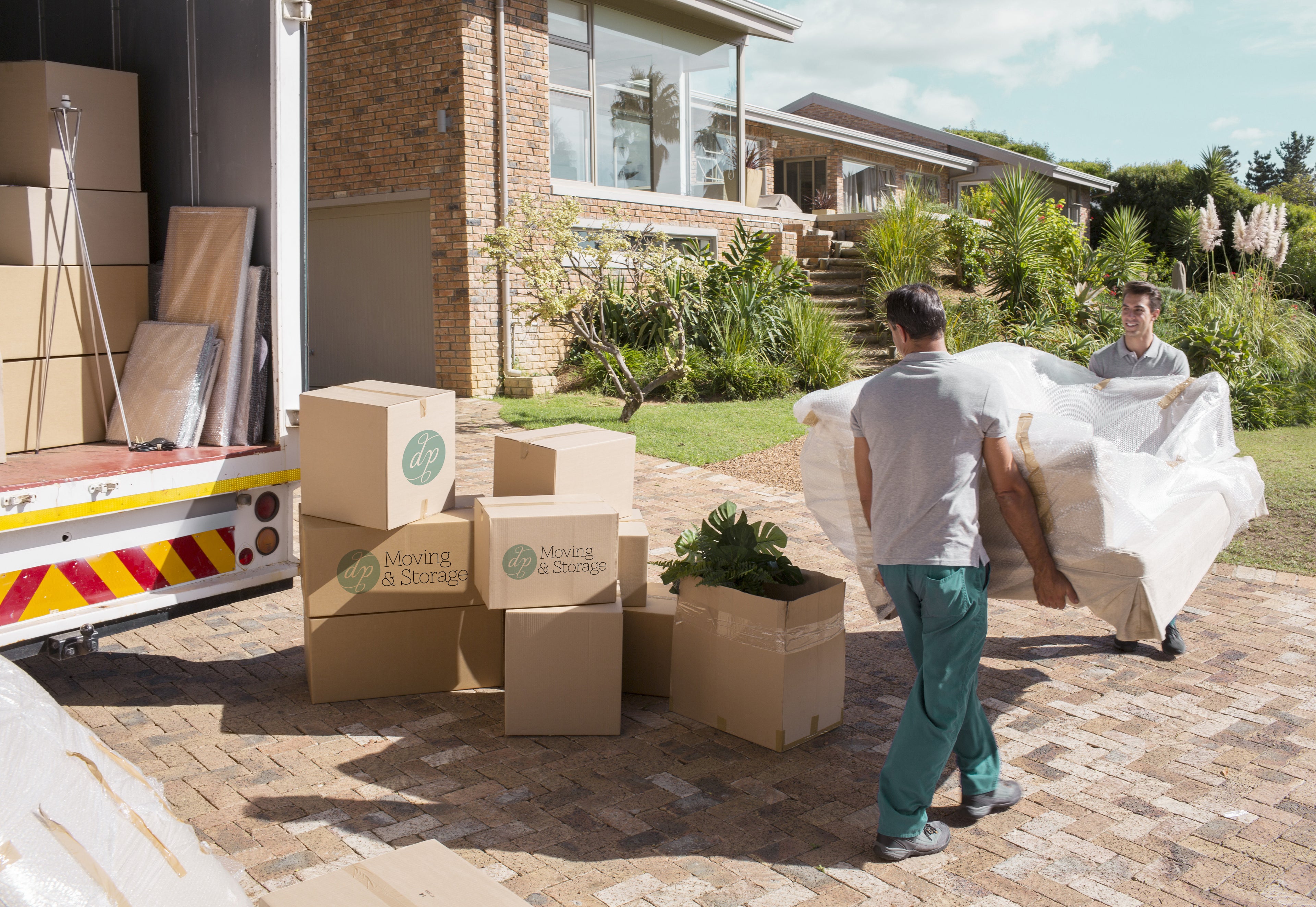 DP Moving & Storage in-house crew carefully moving furniture and packed boxes during a local residential move in South Florida