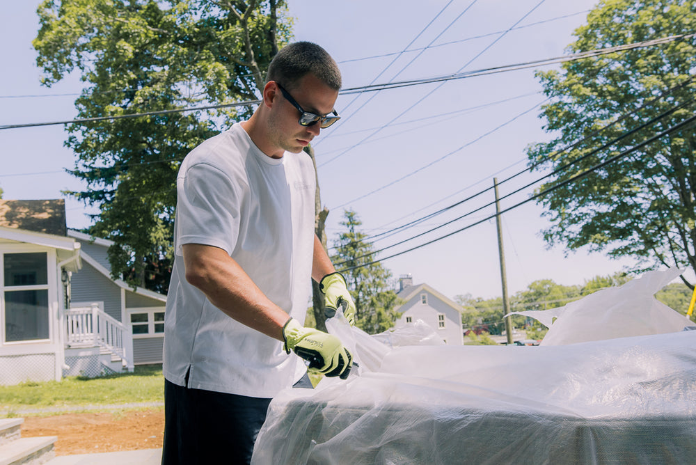 A DP delivery team member protecting furniture outside a home